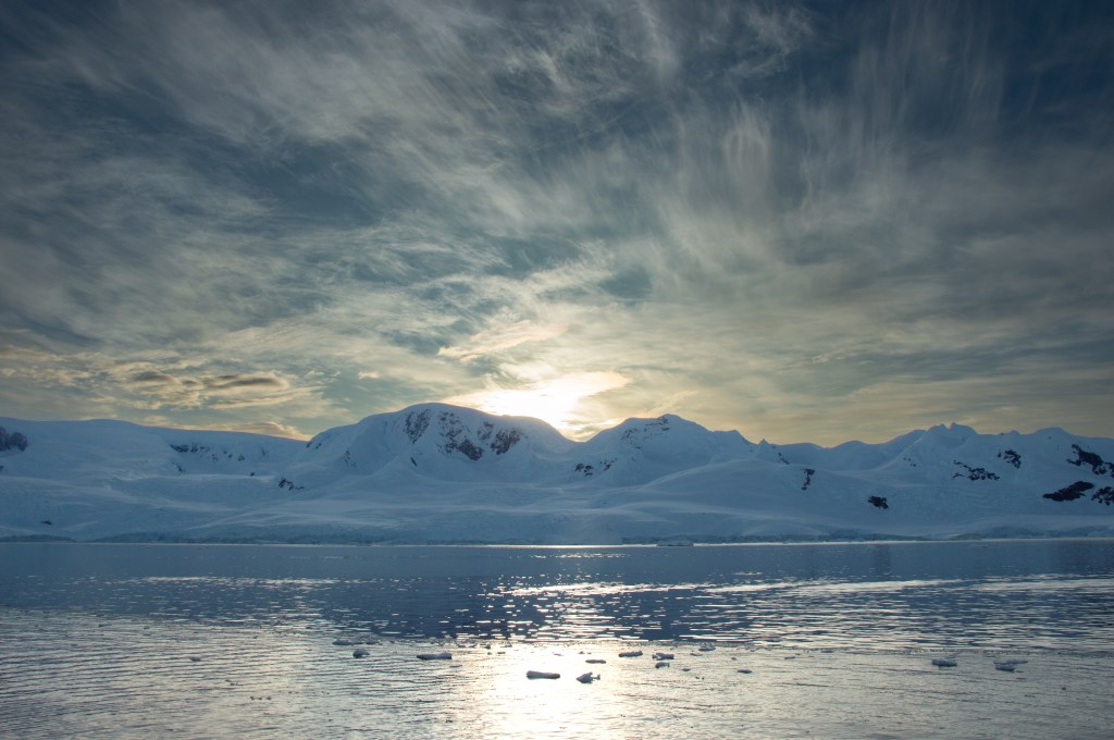 Sun behind mountains, Antarctica