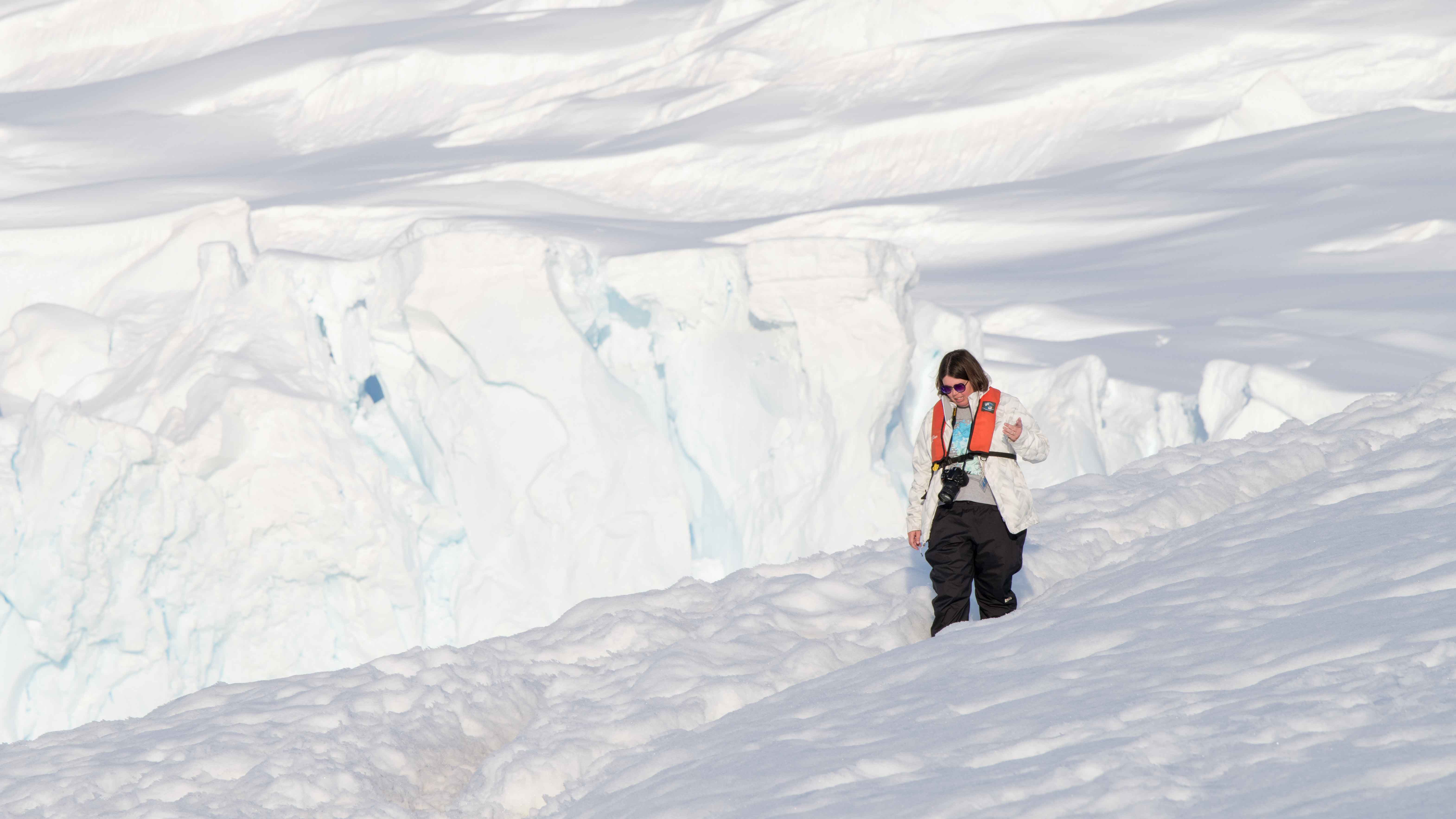 Elizabeth Nyman walking through snow in Antarctica. Photo by Martin Rosas. 